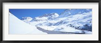 Framed Snow covered mountains on both sides of a road, St Moritz, Graubunden, Switzerland
