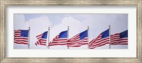 Framed Low angle view of American flags fluttering in wind