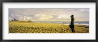 Framed USA, California, Businessman standing holding binoculars and looking at the lighthouse