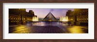 Framed Museum lit up at night with ghosted image of three men, Louvre Museum, Paris, France