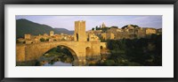 Framed Arch bridge across a river in front of a city, Besalu, Catalonia, Spain