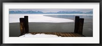 Framed Frozen lake in front of snowcapped mountains, Chiemsee, Bavaria, Germany