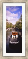 Framed Tourboat docked in a channel, Amsterdam, Netherlands