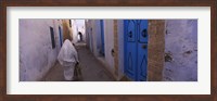 Framed Rear view of a woman walking on the street, Medina, Kairwan, Tunisia