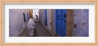 Framed Rear view of a woman walking on the street, Medina, Kairwan, Tunisia