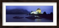 Framed Castle lit up at dusk, Eilean Donan Castle, Loch Duich, Dornie, Highlands Region, Scotland