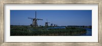 Framed Traditional windmills at a riverbank, Kinderdijk, Rotterdam, Netherlands