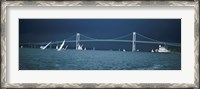 Framed Storm approaches sailboats racing past Rose Island lighthouse and Newport Bridge in Narragansett Bay, Newport, Rhode Island USA