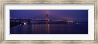 Framed Suspension bridge lit up at dawn viewed from fishing pier, Golden Gate Bridge, San Francisco Bay, San Francisco, California, USA