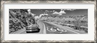 Framed Vintage car moving on Route 66 in black and white, Arizona
