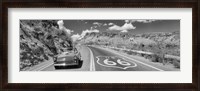 Framed Vintage car moving on Route 66 in black and white, Arizona