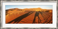 Framed Shadows of camel riders in the desert at sunset, Sahara Desert, Morocco