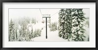 Framed Chair lift and snowy evergreen trees at Stevens Pass, Washington State, USA