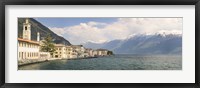 Framed Buildings at the waterfront with snowcapped mountain in the background, Gargnano, Monte Baldo, Lake Garda, Lombardy, Italy