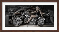 Framed Female model with a motorcycle in a workshop