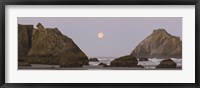 Framed Sea stacks and setting moon at dawn, Bandon Beach, Oregon, USA