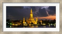 Framed Buddhist temple lit up at dawn, Wat Arun, Chao Phraya River, Bangkok, Thailand