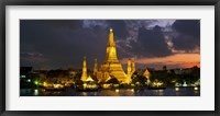 Framed Buddhist temple lit up at dawn, Wat Arun, Chao Phraya River, Bangkok, Thailand