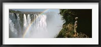Framed Woman looking at a rainbow over the Victoria Falls, Zimbabwe