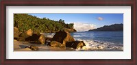 Framed Waves splashing onto rocks on North Island with Silhouette Island in the background, Seychelles
