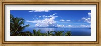 Framed Indian ocean with palm trees towards Mahe Island looking from North Island, Seychelles