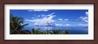Framed Indian ocean with palm trees towards Mahe Island looking from North Island, Seychelles