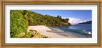 Framed Waves breaking on a small secluded beach on North Island, Seychelles