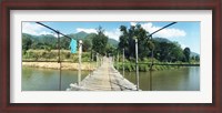 Framed Old wooden bridge across the river, Chiang Mai Province, Thailand