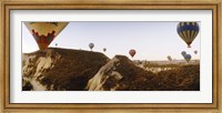 Framed Hot air balloons soaring over a mountain ridge, Cappadocia, Central Anatolia Region, Turkey