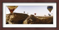 Framed Hot air balloons soaring over a mountain ridge, Cappadocia, Central Anatolia Region, Turkey