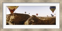 Framed Hot air balloons soaring over a mountain ridge, Cappadocia, Central Anatolia Region, Turkey