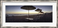 Framed Beach chairs and straw sun umbrellas on Patara Beach on the Mediterranean Sea at sunset, Patara, Antalya Province, Turkey