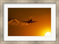 Framed Silhouette of airliner in golden sunset
