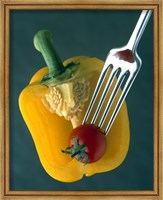 Framed Close up of half yellow pepper with cherry tomato in center on fork tines