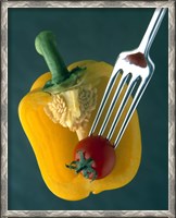 Framed Close up of half yellow pepper with cherry tomato in center on fork tines