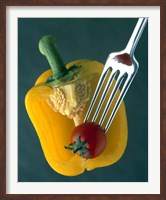 Framed Close up of half yellow pepper with cherry tomato in center on fork tines