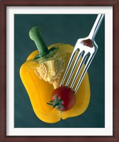 Framed Close up of half yellow pepper with cherry tomato in center on fork tines