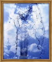 Framed Slow motion geyser of water rising through blue sky and clouds