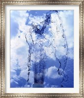 Framed Slow motion geyser of water rising through blue sky and clouds