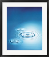 Framed Three rings in blue water with bright light reflection