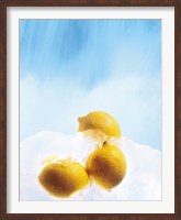 Framed Three lemons frozen in ice below ice blue sky