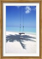 Framed Swing on the beach above palm tree shadow