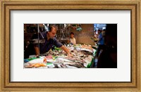 Framed Fishmonger at a fish stall, La Boqueria Market, Ciutat Vella, Barcelona, Catalonia, Spain