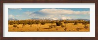 Framed High desert plains landscape with snowcapped Sangre de Cristo Mountains in the background, New Mexico