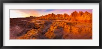 Framed Alpenglow on rock formations at sunrise, Door Trail, Badlands National Park, South Dakota, USA