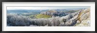Framed Snow covered trees in a valley from Uley Bury, Downham Hill, Gloucestershire, England