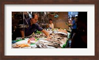 Framed Fishmonger at a fish stall, La Boqueria Market, Ciutat Vella, Barcelona, Catalonia, Spain