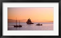 Framed Tugboat with a trawler and a tall ship in the Baie de Douarnenez at sunrise, Finistere, Brittany, France