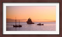 Framed Tugboat with a trawler and a tall ship in the Baie de Douarnenez at sunrise, Finistere, Brittany, France
