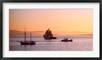 Framed Tugboat with a trawler and a tall ship in the Baie de Douarnenez at sunrise, Finistere, Brittany, France